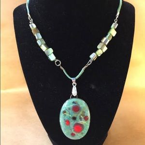 Oval-enamel pendant  green with red/yellow frit, l